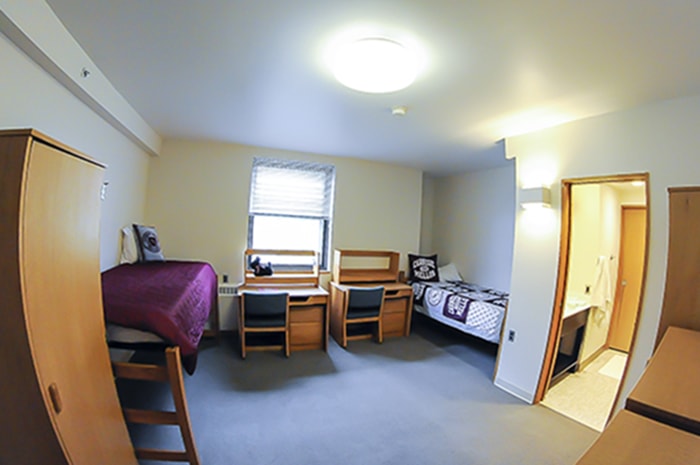 McGill House Semi-Suite Double - two desks beds a dresser and doorway to bathroom